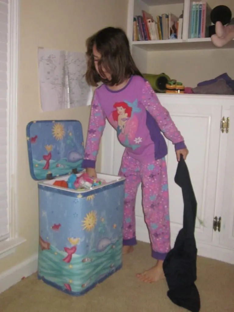 kid picking up laundry