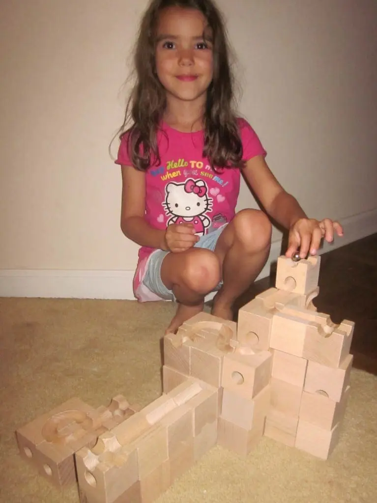 6 year old playing with Cuboro Standard Wooden Marble Run