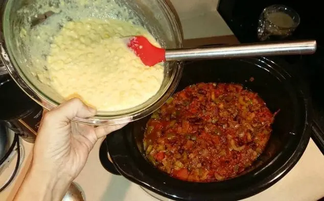 pour cornbread topping over chili