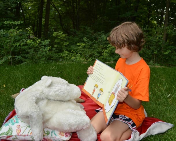 reading to his stuffed animal