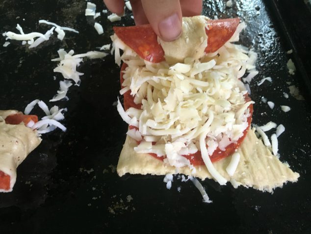 rolling a pepperoni roll