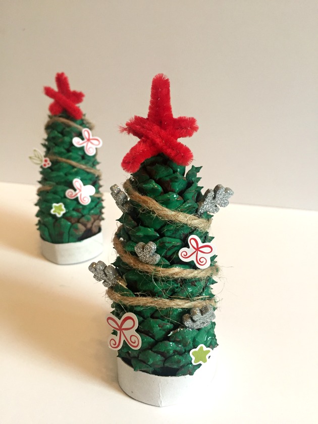 pine cones decorated as Christmas trees