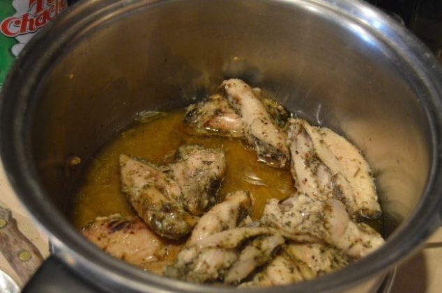 Hot wings in crock pot with fat rendered in slow cooking chicken wings